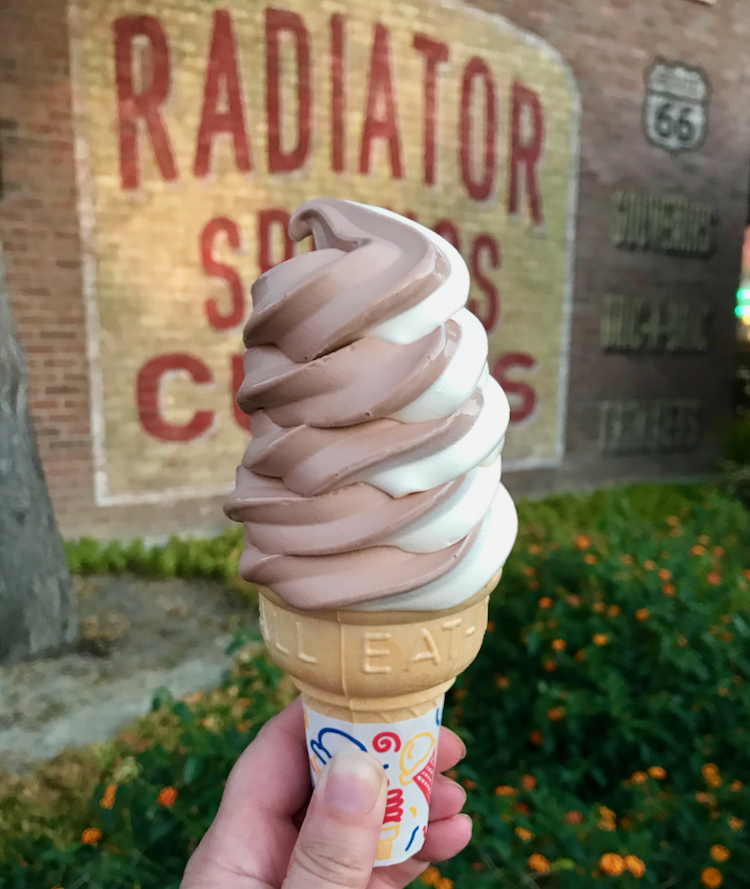 soft serve ice cream cone in front of the Radiator Springs sign in Disneyland